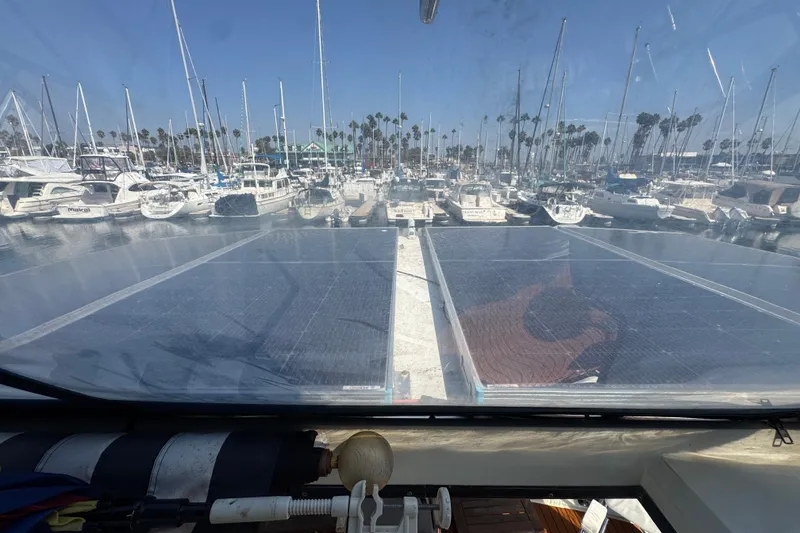 Slide: The Image of 1985 Carver 3607 Aft Cabin Motor Yacht with solar panels in a marina setting. - 36