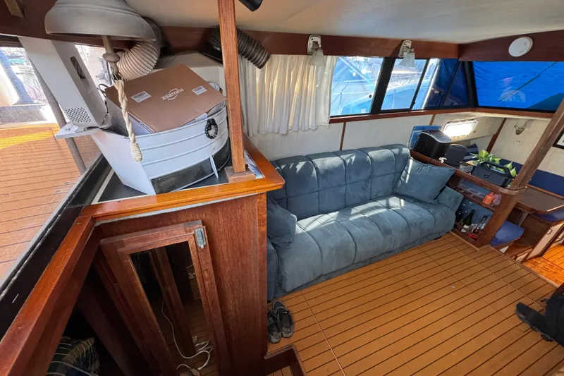 Slide: The Image of 1985 Carver 3607 Aft Cabin Motor Yacht interior with sofa and wooden flooring. - 38