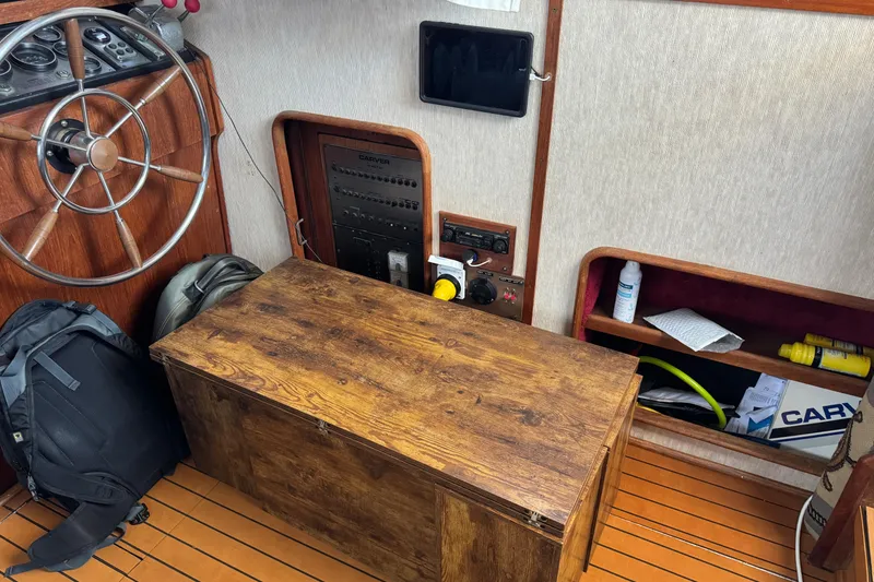 Slide: The Image of 1985 Carver 3607 Aft Cabin Motor Yacht interior with helm, wooden storage, and equipment. - 41