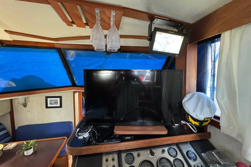 Slide: The Image of Interior of 1985 Carver 3607 Aft Cabin Motor Yacht with TV and navigation equipment. - 46
