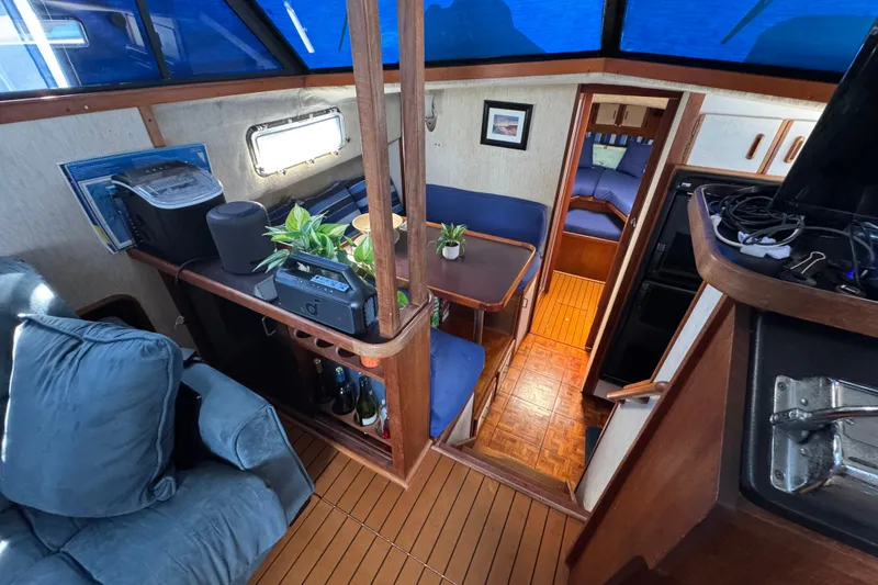 Slide: The Image of Interior of 1985 Carver 3607 Aft Cabin Motor Yacht with cozy seating and wooden accents. - 48