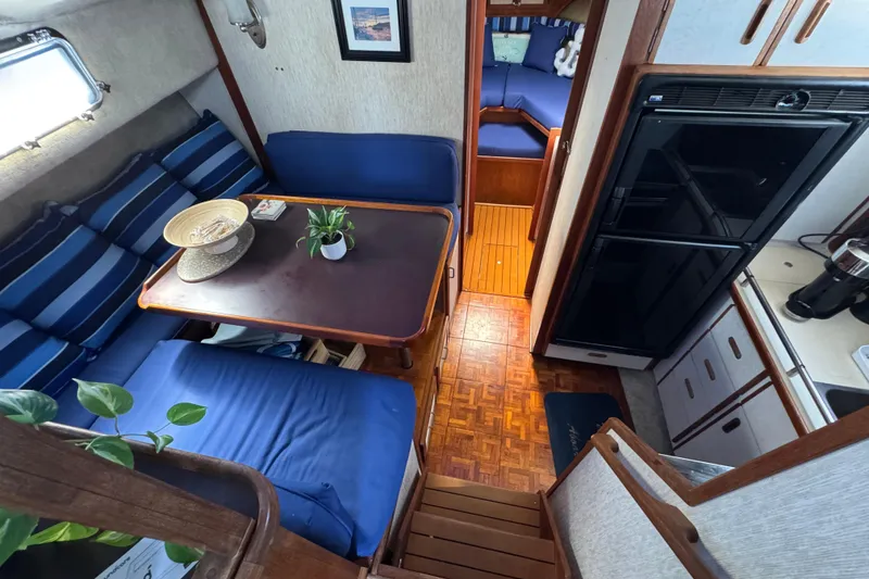 Slide: The Image of Interior of 1985 Carver 3607 Aft Cabin Motor Yacht with cozy seating and kitchenette. - 49