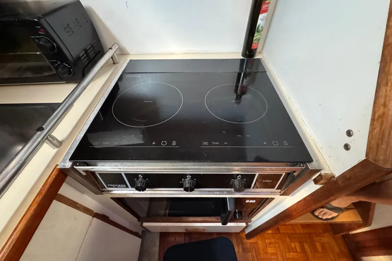 Slide: The Image of Induction cooktop in 1985 Carver 3607 Aft Cabin Motor Yacht kitchen. - 54