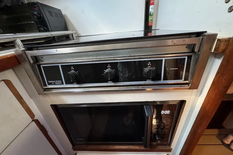 Slide: The Image of 1985 Carver 3607 Aft Cabin Motor Yacht kitchen with Princess stove and microwave. - 55