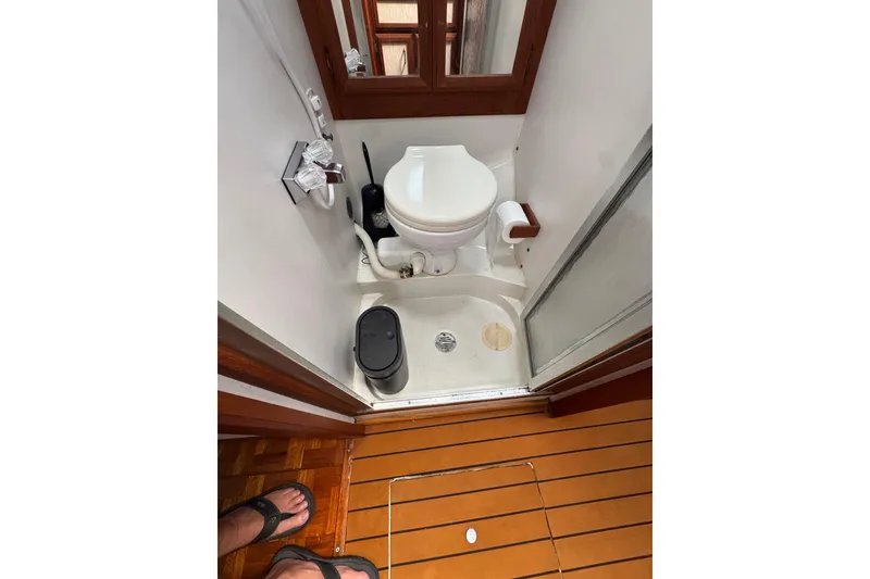 Slide: The Image of 1985 Carver 3607 Aft Cabin Motor Yacht bathroom with toilet and shower. - 61