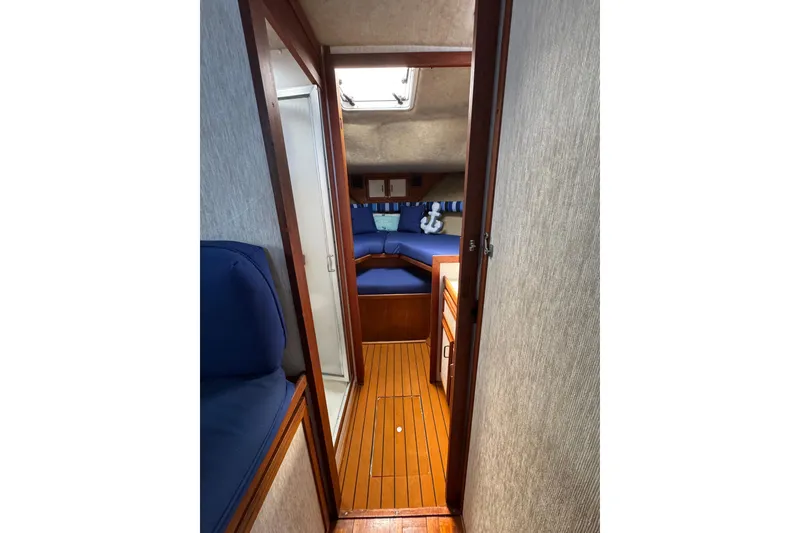 Slide: The Image of 1985 Carver 3607 Aft Cabin Motor Yacht interior with wood flooring and blue seating. - 65