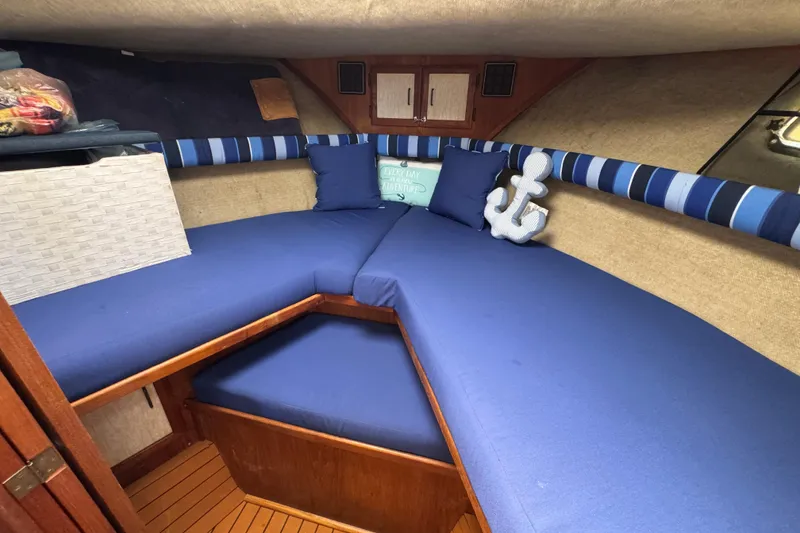 Slide: The Image of 1985 Carver 3607 Aft Cabin Motor Yacht interior with blue cushions and nautical decor. - 67