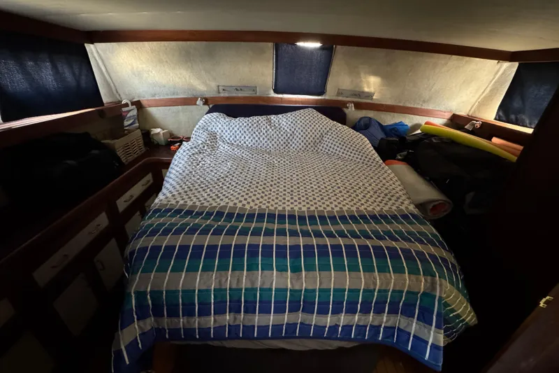 Slide: The Image of Cozy cabin interior of 1985 Carver 3607 Aft Cabin Motor Yacht with bed and storage. - 69