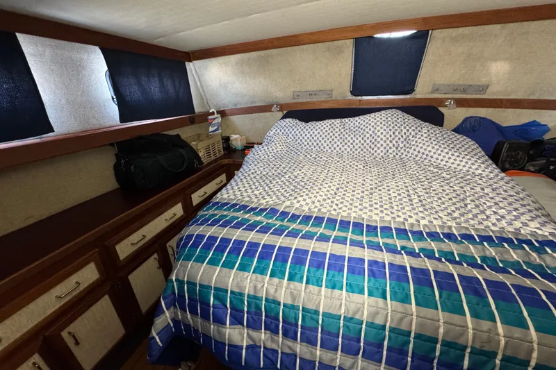 Slide: The Image of 1985 Carver 3607 Aft Cabin Motor Yacht interior with bed and storage cabinets. - 70