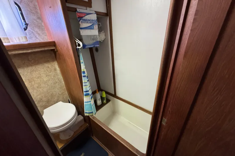 Slide: The Image of 1985 Carver 3607 Aft Cabin Motor Yacht bathroom with toilet and shower. - 75