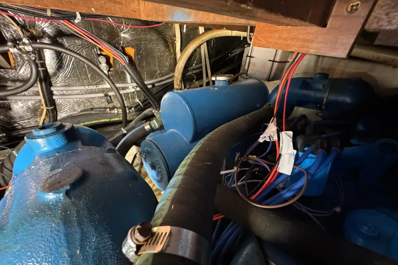 Slide: The Image of Engine room of 1985 Carver 3607 Aft Cabin Motor Yacht with blue components and wiring. - 80