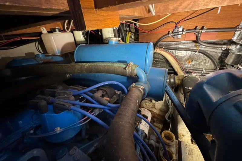 Slide: The Image of Engine compartment of 1985 Carver 3607 Aft Cabin Motor Yacht with blue components and wiring. - 81
