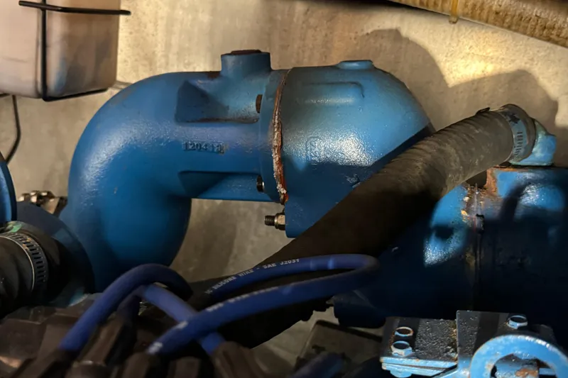 Slide: The Image of Engine component of 1985 Carver 3607 Aft Cabin Motor Yacht, featuring blue piping and hoses. - 83