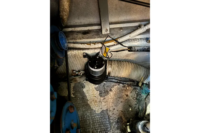 Slide: The Image of Engine room of 1985 Carver 3607 Aft Cabin Motor Yacht, showing mechanical components. - 86