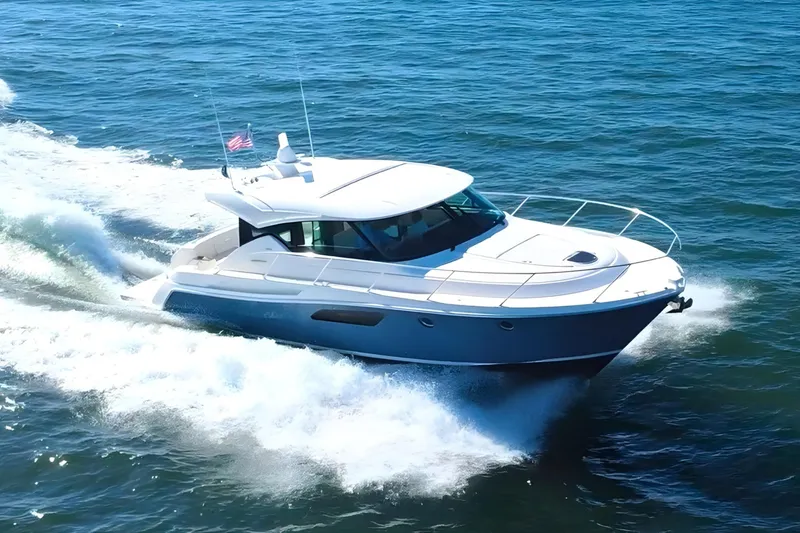 The Image of 2018 Tiara Yachts C44 Coupe cruising on open water, showcasing sleek design and performance. - 0