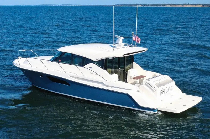 Slide: The Image of 2018 Tiara Yachts C44 Coupe cruising on open water, showcasing sleek design and luxury. - 1