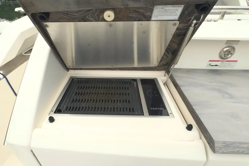 Slide: The Image of Outdoor grill on 2018 Tiara Yachts C44 Coupe, featuring Kenyon electric cooktop. - 12