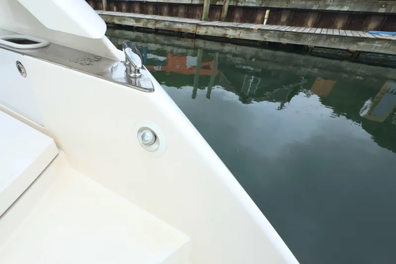 Slide: The Image of 2018 Tiara Yachts C44 Coupe docked, showcasing sleek design and water reflection. - 13