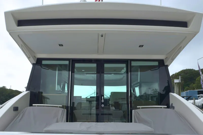 Slide: The Image of 2018 Tiara Yachts C44 Coupe, rear view with glass doors and seating area. - 14