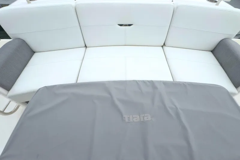Slide: The Image of White seating area on 2018 Tiara Yachts C44 Coupe with gray cover. - 16