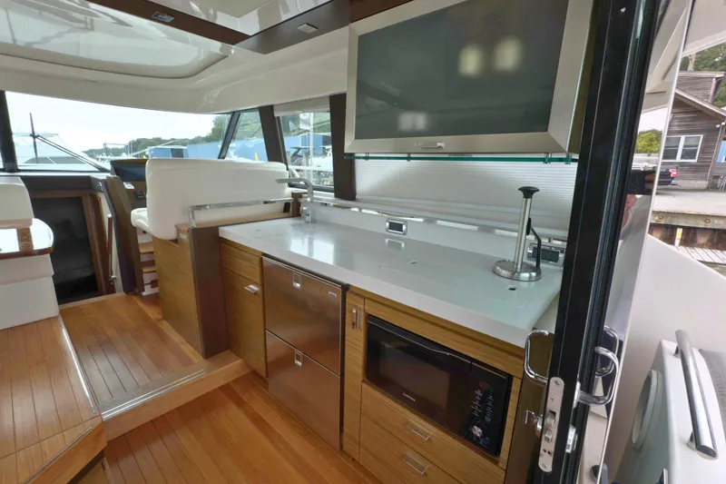 Slide: The Image of Interior of 2018 Tiara Yachts C44 Coupe with modern kitchen and sleek design. - 21