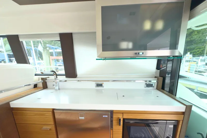 Slide: The Image of Interior of 2018 Tiara Yachts C44 Coupe, featuring modern kitchen with sleek cabinetry. - 23
