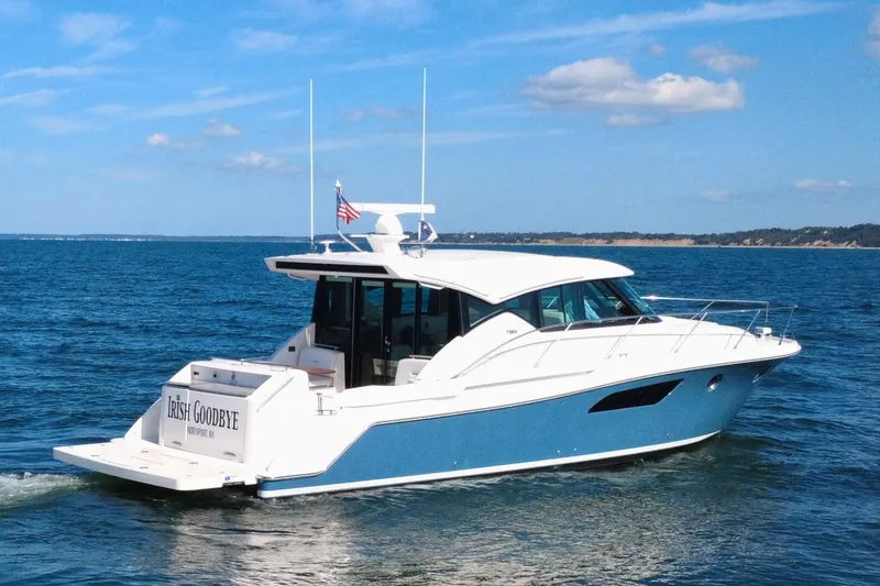 Slide: The Image of 2018 Tiara Yachts C44 Coupe cruising on open water under a clear sky. - 3