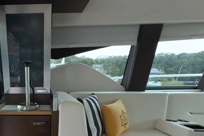 Slide: The Image of Interior of 2018 Tiara Yachts C44 Coupe with modern seating and scenic window view. - 32