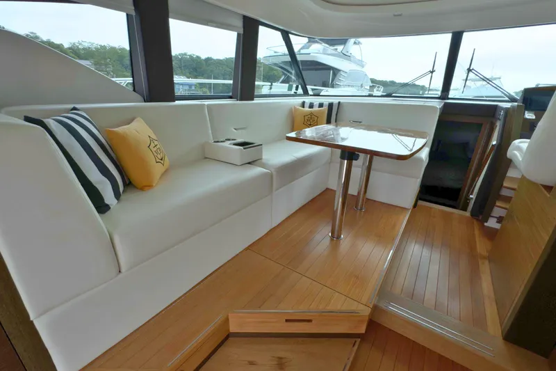 Slide: The Image of Interior of 2018 Tiara Yachts C44 Coupe with elegant seating and wooden flooring. - 33