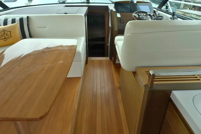 Slide: The Image of Interior of 2018 Tiara Yachts C44 Coupe featuring elegant wood flooring and plush seating. - 34