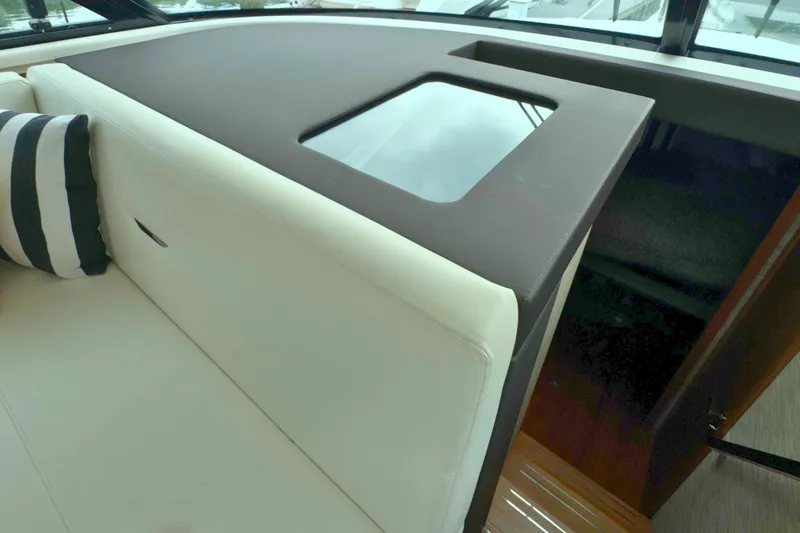 Slide: The Image of Interior of 2018 Tiara Yachts C44 Coupe with white seating and striped pillow. - 37