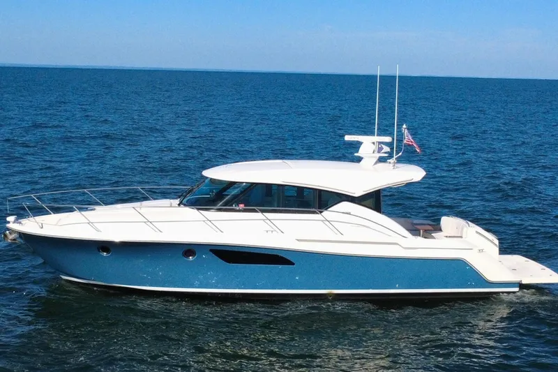 Slide: The Image of 2018 Tiara Yachts C44 Coupe cruising on open sea under clear blue sky. - 4