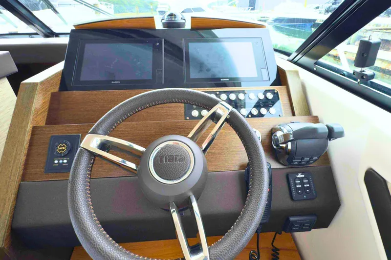 Slide: The Image of Steering console of 2018 Tiara Yachts C44 Coupe with modern navigation displays. - 41