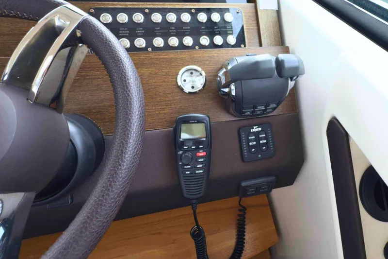 Slide: The Image of 2018 Tiara Yachts C44 Coupe helm with controls and communication equipment. - 43