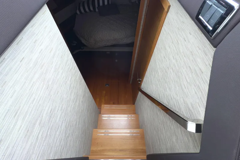 Slide: The Image of Staircase leading to cabin in 2018 Tiara Yachts C44 Coupe, featuring modern interior design. - 46