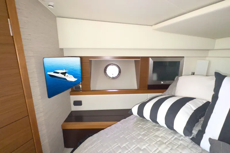 Slide: The Image of 2018 Tiara Yachts C44 Coupe interior cabin with modern decor and porthole window. - 48