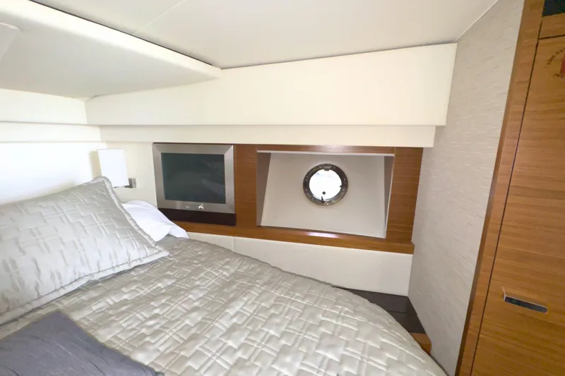 Slide: The Image of Luxurious bedroom interior of 2018 Tiara Yachts C44 Coupe with porthole and TV. - 49