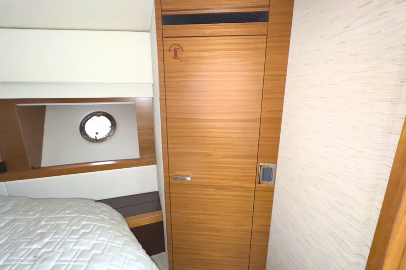 Slide: The Image of Interior cabin of 2018 Tiara Yachts C44 Coupe with wooden door and porthole. - 50