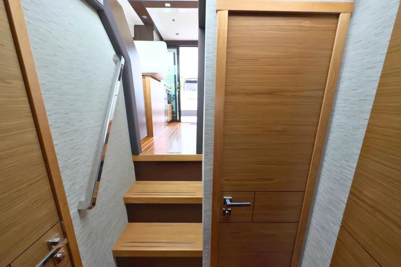 Slide: The Image of Interior of 2018 Tiara Yachts C44 Coupe with wooden doors and a wall-mounted screen. - 51