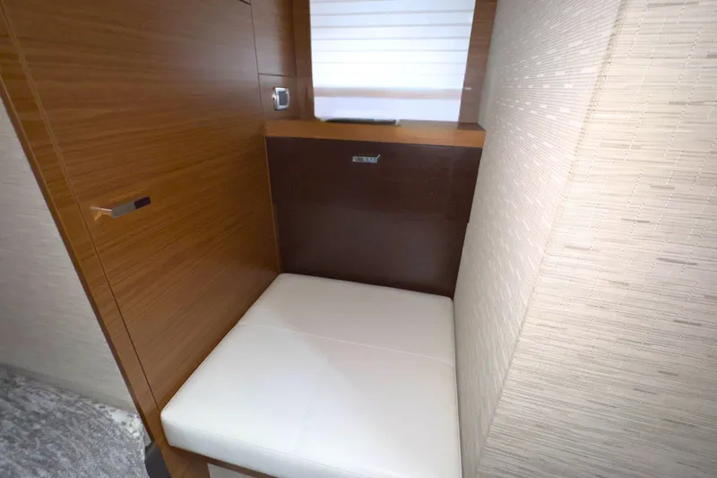 Slide: The Image of Interior of 2018 Tiara Yachts C44 Coupe, featuring wooden stairs and door. - 53