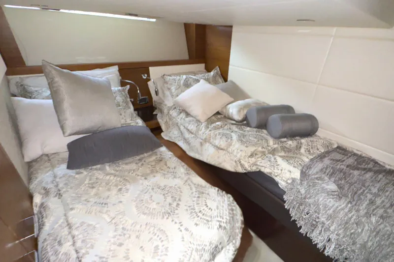 Slide: The Image of 2018 Tiara Yachts C44 Coupe cabin interior with cozy bed and modern decor. - 54