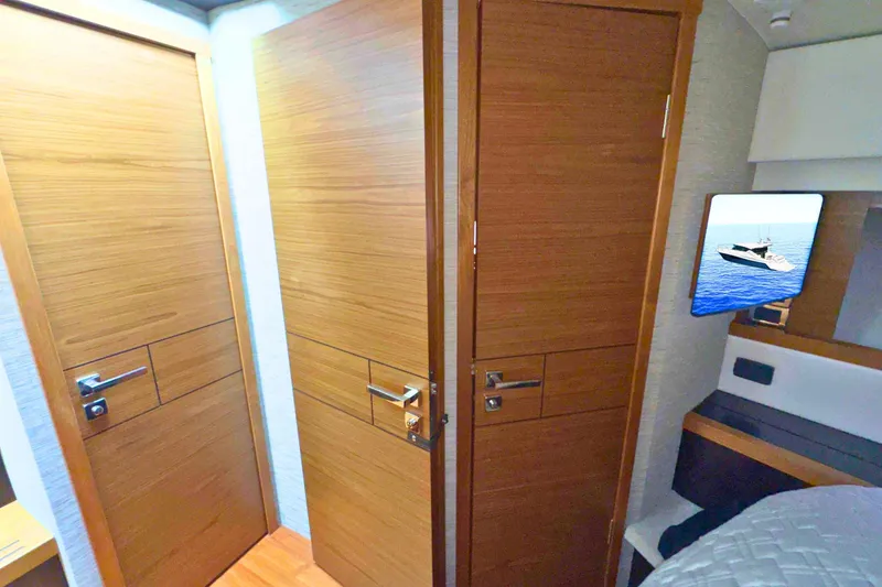 Slide: The Image of Interior of 2018 Tiara Yachts C44 Coupe, featuring wooden door and staircase. - 57