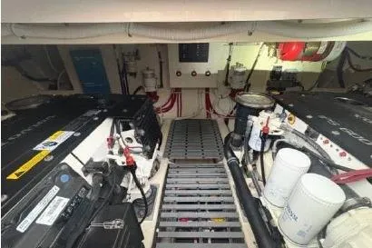 Slide: The Image of Engine room of 2018 Tiara Yachts C44 Coupe, showcasing dual engines and mechanical components. - 59