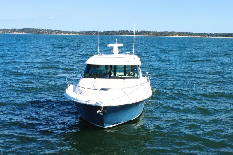 Slide: The Image of 2018 Tiara Yachts C44 Coupe cruising on open water. - 7