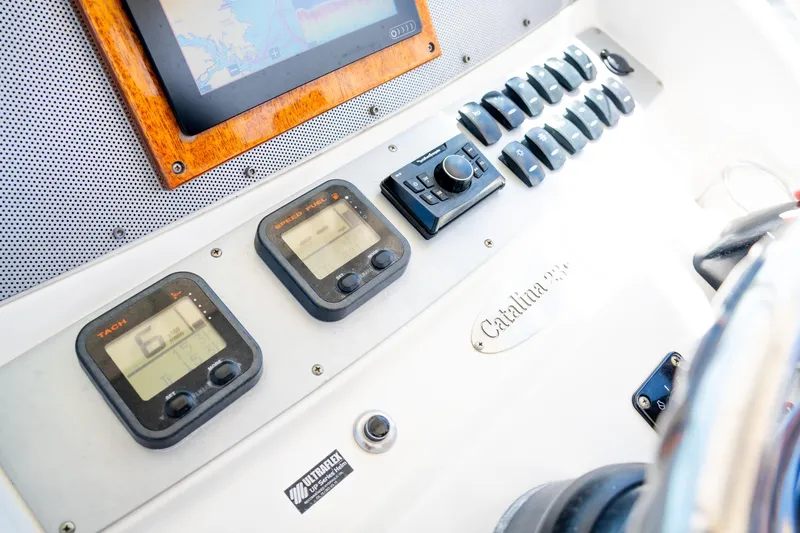 Slide: The Image of Dashboard of a 2007 Chris-Craft Catalina 23 boat with gauges and controls. - 10