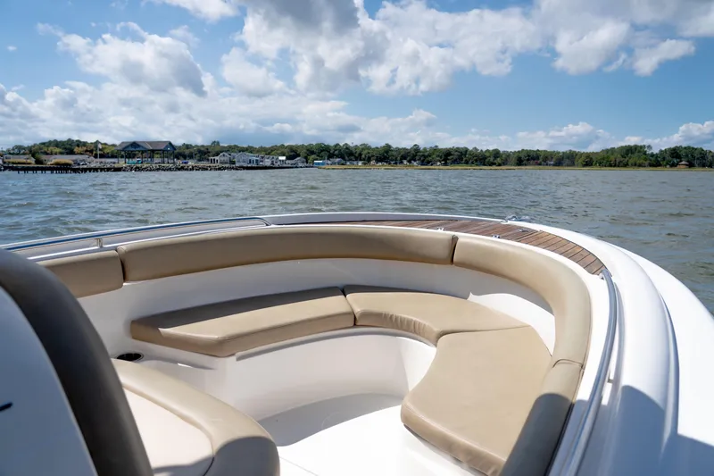 Slide: The Image of 2007 Chris-Craft Catalina 23 boat interior with beige seating, on a sunny day by the water. - 15