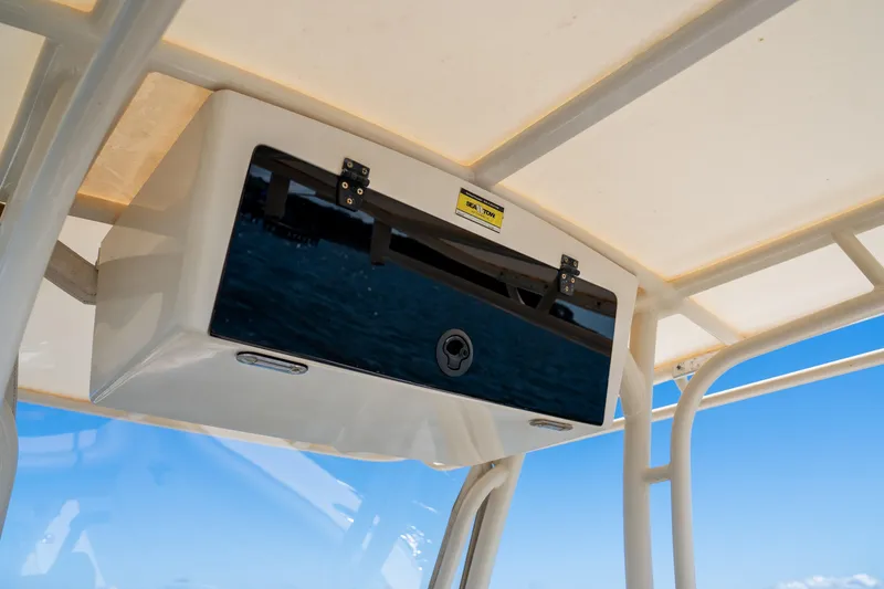 Slide: The Image of 2007 Chris-Craft Catalina 23 boat storage compartment under canopy with blue sky background. - 16