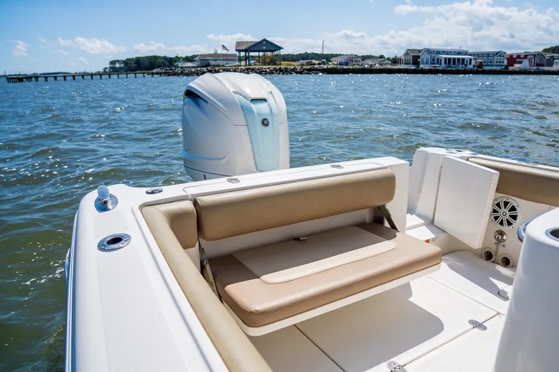 Slide: The Image of 2007 Chris-Craft Catalina 23 boat interior with seating and outboard motor on a sunny day. - 5
