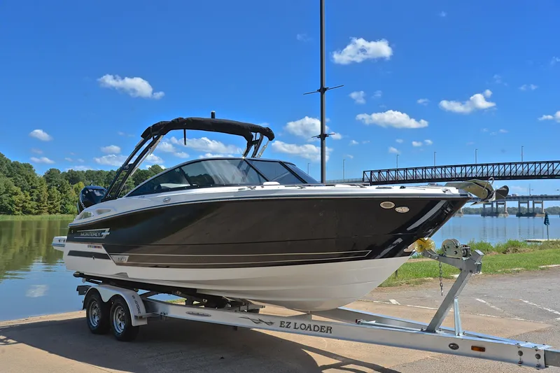 Slide: The Image of 2023 Monterey 275SS Super Sport boat on trailer by a scenic lake. - 16
