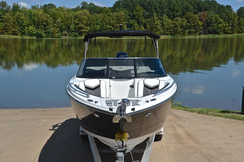 Slide: The Image of 2023 Monterey 275SS Super Sport boat on trailer by a serene lake. - 17